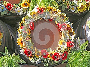 Wine barrels decorated with wreaths of autumn flowers