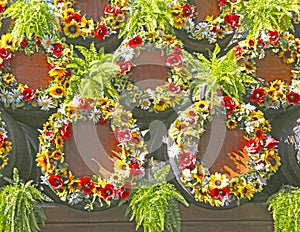 Wine barrels decorated with wreaths of autumn flowers