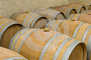 Wine barrels stacked in the cellar of the winery. Wine barrels in wine-vaults