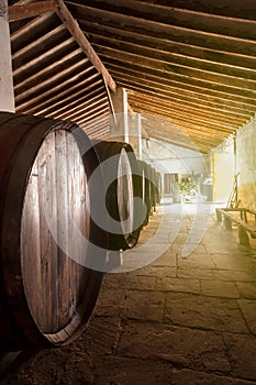 Wine barrels stacked in the old cellar of the vinery in Spain