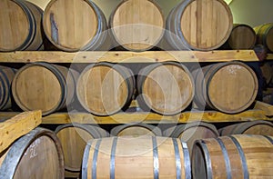 Wine barrels stacked in a old cellar at winery