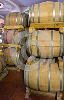 Wine barrels stacked in a old cellar at winery