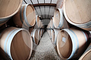 Wine barrels stacked in old winery cellar