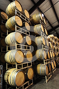 Wine barrels stacked in winery side