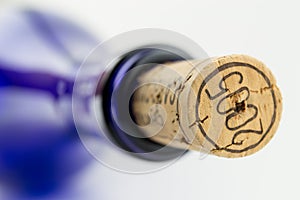 Blue bottle wine with a cork isolated on white bac
