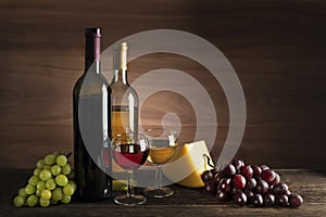 Wine bootle and glass with food on wooden table
