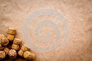 Wine bottle corks on craft paper background top view copyspace. New Year celebration concept