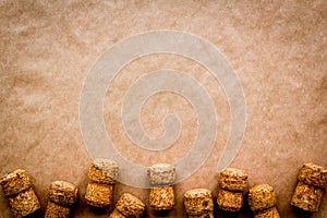 Wine bottle corks pattern on craft paper background top view copyspace. New Year celebration concept