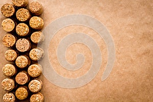 Wine bottle corks pattern on craft paper background top view copyspace. New Year celebration concept