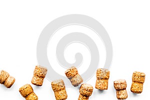 Wine bottle corks pattern on white background top view copyspace. New Year celebration concept