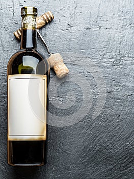 Wine bottle and corkscrew.