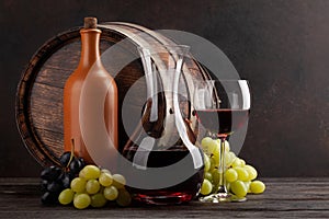 Wine bottle, decanter, glass and old wooden barrel