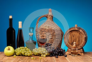 Wine bottle and glass, apples and grapes