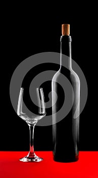 Wine bottle and glass silhouette with high contrast on red and black