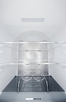 Wine bottle holders in the cold storage compartment. An empty refrigerator. Inside an empty, clean refrigerator, a