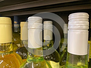 Wine bottle tops and necks white and gold background