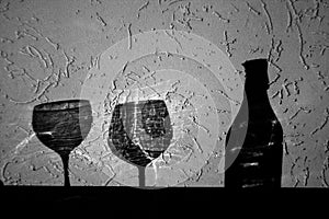 Wine bottle and two glasses shadow in black and white