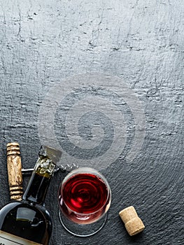 Wine bottle, wine glass and corkscrew.