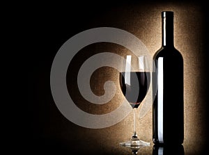 Wine bottle and wineglass on a old background