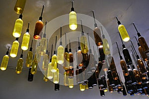 Wine bottles as lamps installed on the ceiling