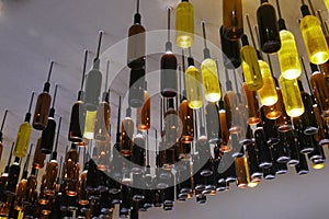 Wine bottles as lamps installed on the ceiling