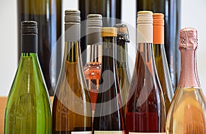 Wine bottles of different sizes in wine store and ready for home delivery