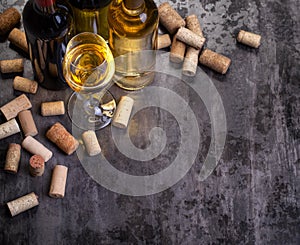 Wine bottles , glass and corks on table