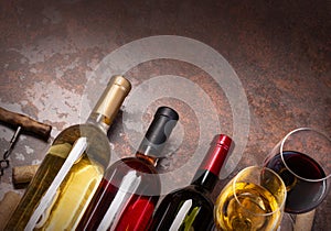 Wine bottles , glass and corks on table