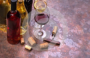 Wine bottles , glass and corks on table