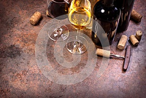 Wine bottles , glass and corks on table