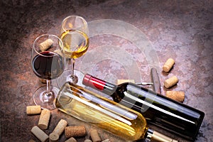 Wine bottles , glass and corks on table