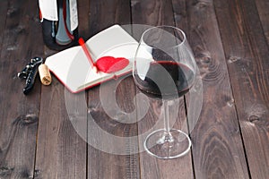 Wine bottles with glass, wooden background