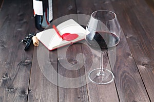 Wine bottles with glass, wooden background