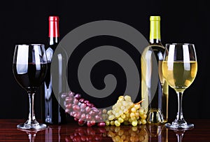 Wine Bottles and Glasses of Wine over black