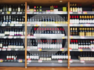 Wine bottles on shelf Supermarket Liquor store Blur background