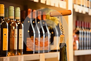 Wine bottles in wine store and corks with corkscrew