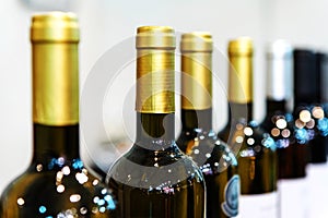 Wine bottles. Trade in alcoholic beverages in the store. Close-up