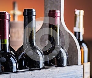 Wine bottles in wooden crate and oak wine keg.