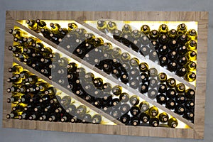 Wine bottles in a wooden rack in the wine cellar. Storage of wine