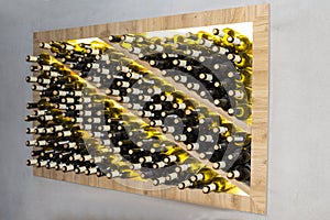 Wine bottles in a wooden rack in the wine cellar. Storage of wine