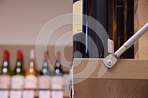 Wine bottles on wooden shelf in wine store