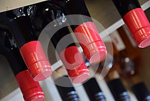 Wine bottles on wooden shelf in wine store