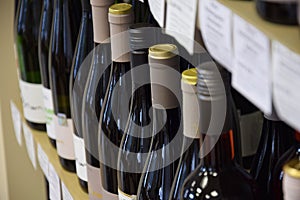 Wine bottles on wooden shelf in wine store, View from the top