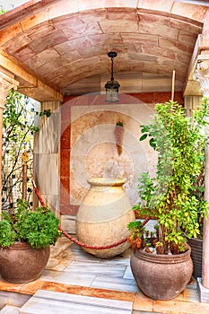 Wine bowl and clay pots with plants near the Cana greek orthodox wedding church in Cana of Galilee, Kfar Kana, Israel