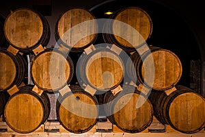 Wine or brandy barrels at a winery. Stacks of wine or brandy barrels. An old whiskey barrel. An old single malt whisky.