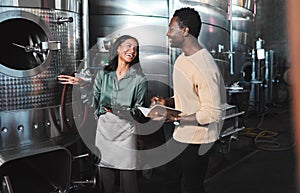 Wine business manufacturing warehouse factory, winery tank cellar brewery warehouse. Happy female winemaker employee at