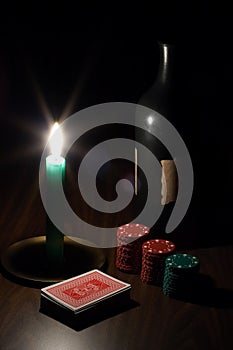 Wine, candle, playing cards and chips