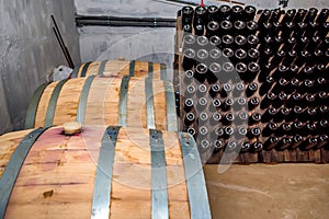 Wine casks and bottles in cellar