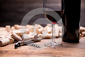 Wine concept flat lay still life with wine bottle and glass of wine, corks and corkscrew