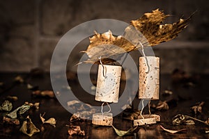 Wine cork figures, Concept two men carry a leaf